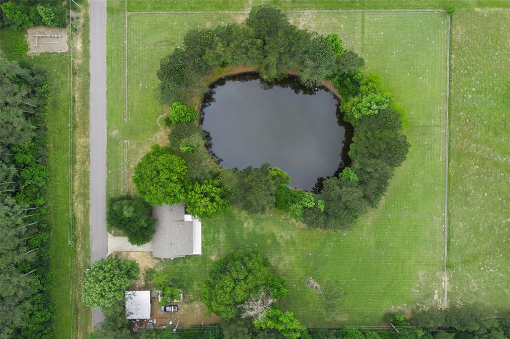 9720 Locust Hill Road Greenwood, LA 71033 - Photo 5 of 31 an aerial view of a house with a yard and trees