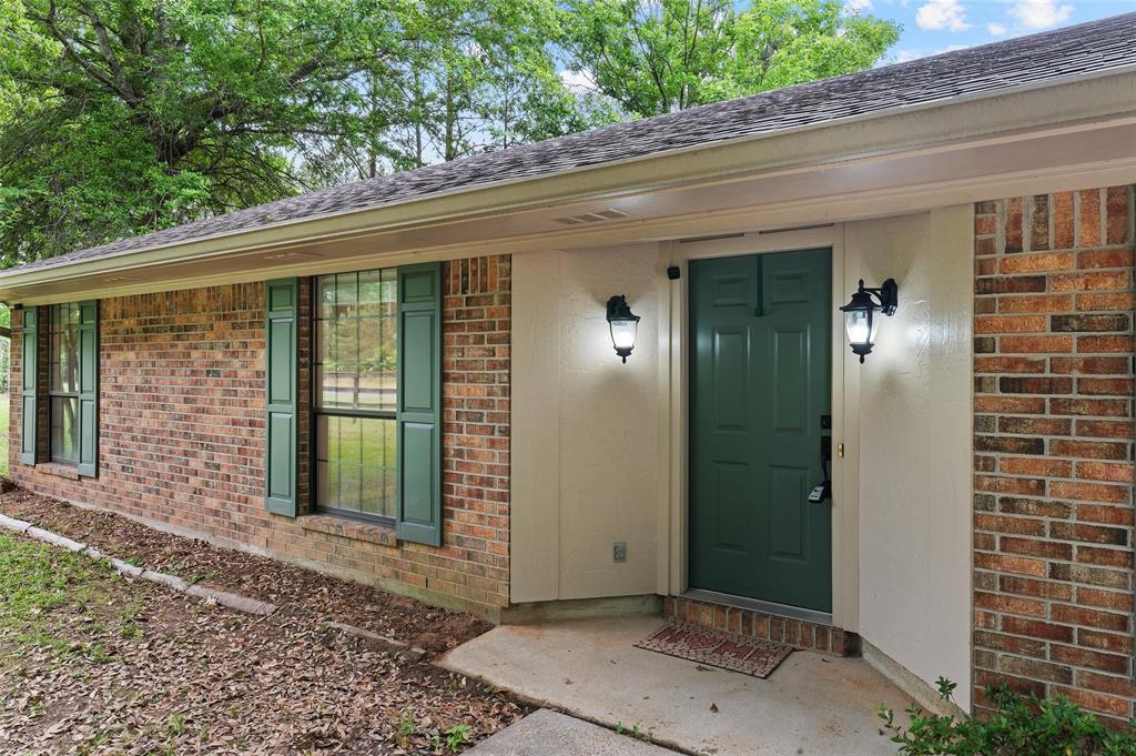 9720 Locust Hill Road Greenwood, LA 71033 - Photo 10 of 31 a view of a front door of a house with a porch