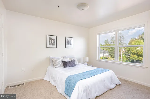 a bedroom with a large bed and a window