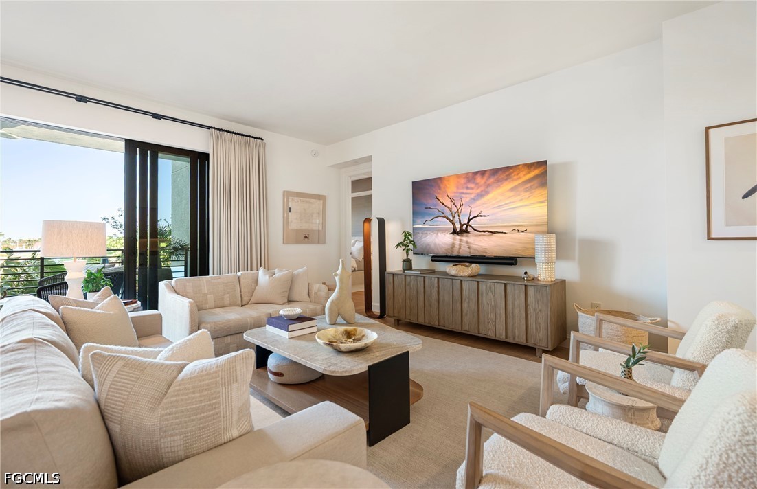 1115 Central Avenue, Unit 443 Naples, FL 34102 - Photo 12 of 40 a living room with furniture and a flat screen tv