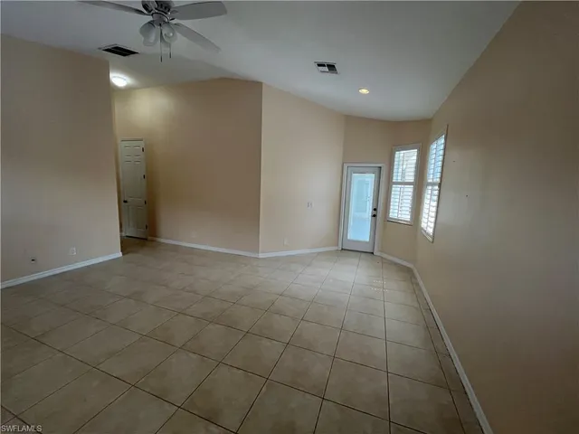 a view of an empty room with a window