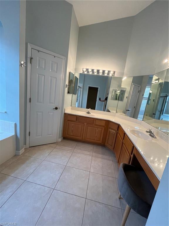 366 Burnt Pine Drive Naples, FL 34119 - Photo 14 of 36 a room with a bed and a television in it