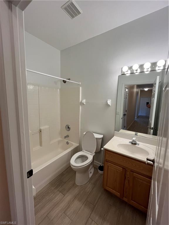 366 Burnt Pine Drive Naples, FL 34119 - Photo 18 of 36 a bathroom with a double vanity sink toilet mirror and bathtub