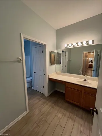 a spacious bathroom with a double vanity sink and mirror