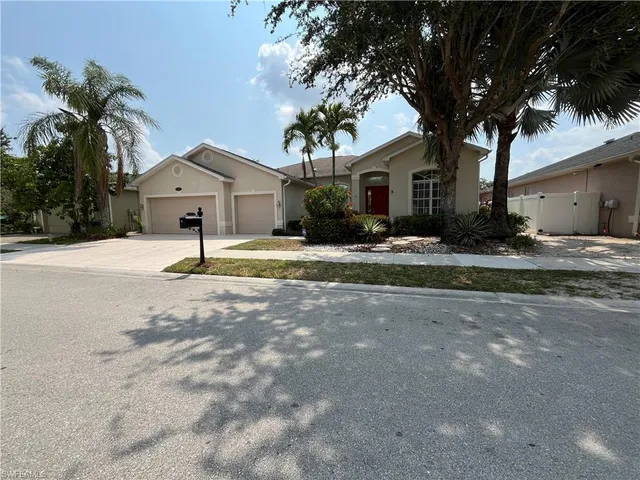 a front view of house with yard and green space