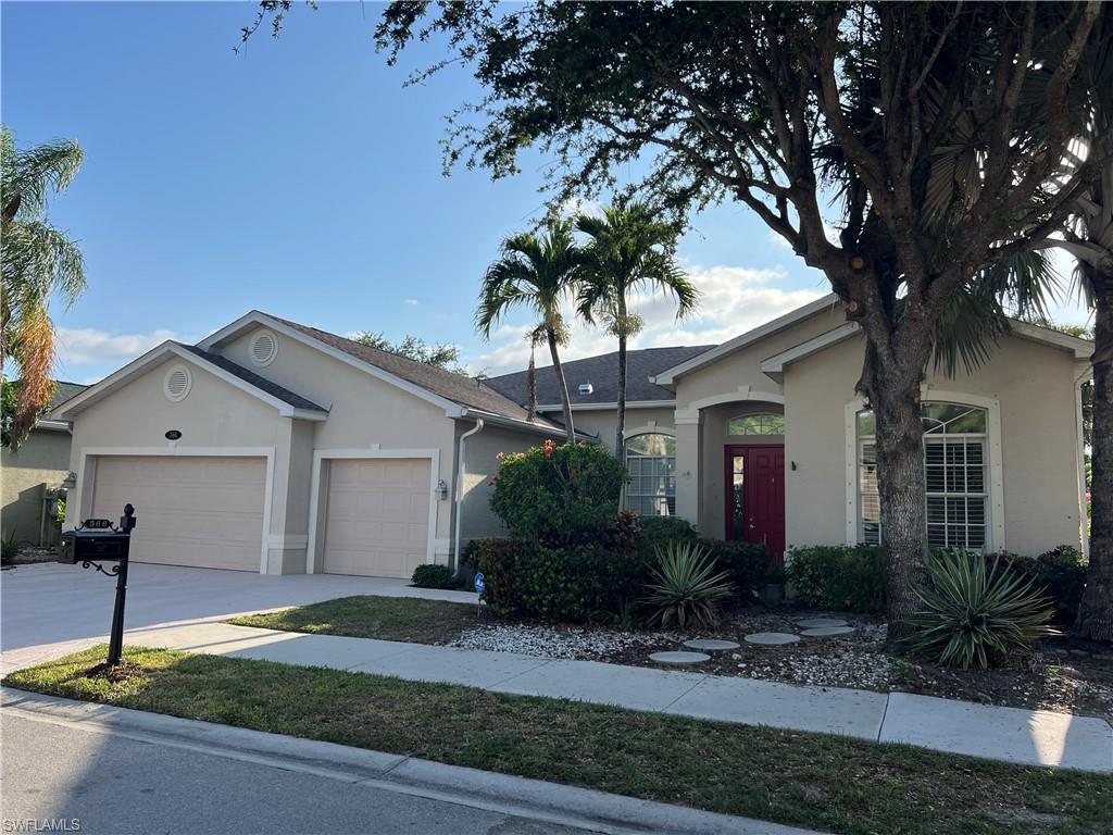 366 Burnt Pine Drive Naples, FL 34119 - Photo 29 of 36 a front view of house with yard and green space
