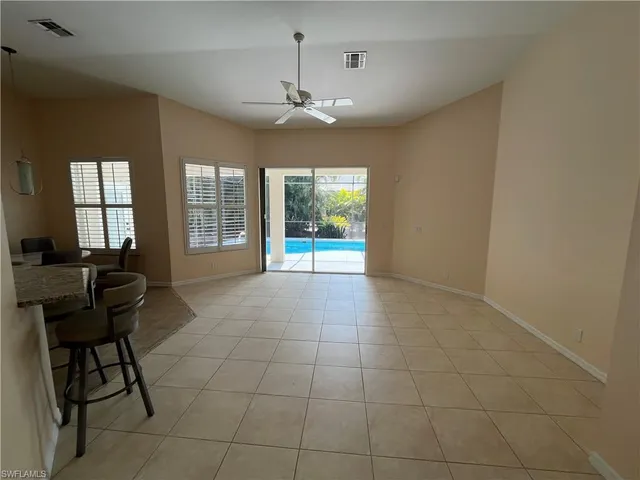 a view of a livingroom with a piano and wooden floor