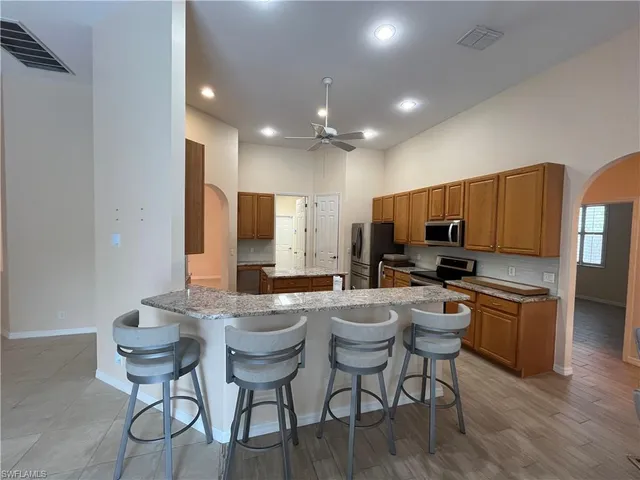 a large kitchen with a table and chairs