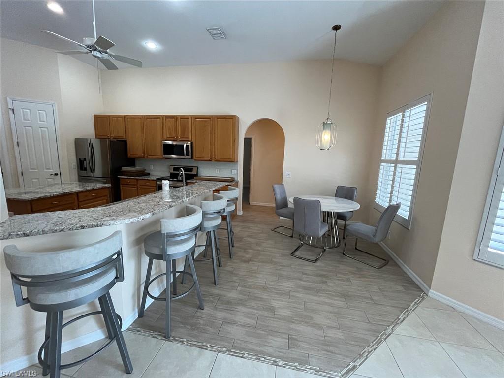 366 Burnt Pine Drive Naples, FL 34119 - Photo 9 of 36 a dining room with furniture and a window
