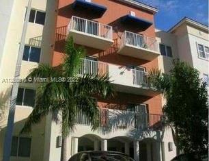 11050 Southwest 196th Street, Unit 305 Miami, FL 33157 - Photo 1 of 9 a front view of a house with a yard