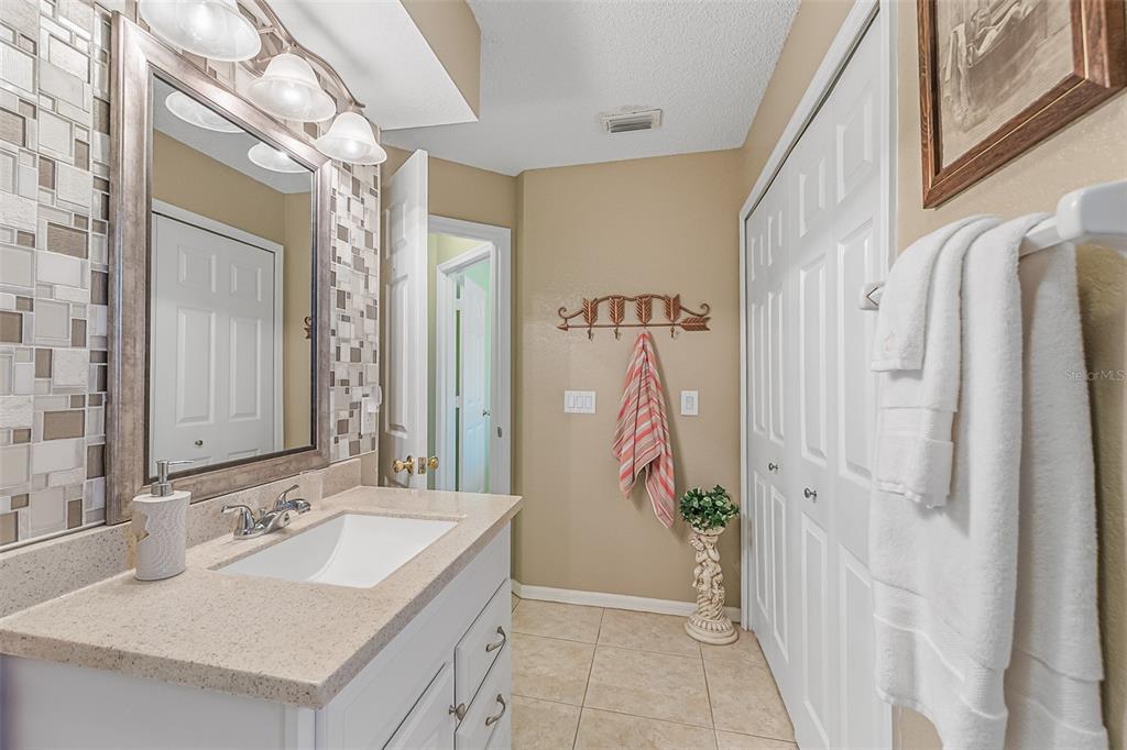 5740 Friendly Street Cocoa, FL 32927 - Photo 12 of 14 a bathroom with a sink a mirror and a shower