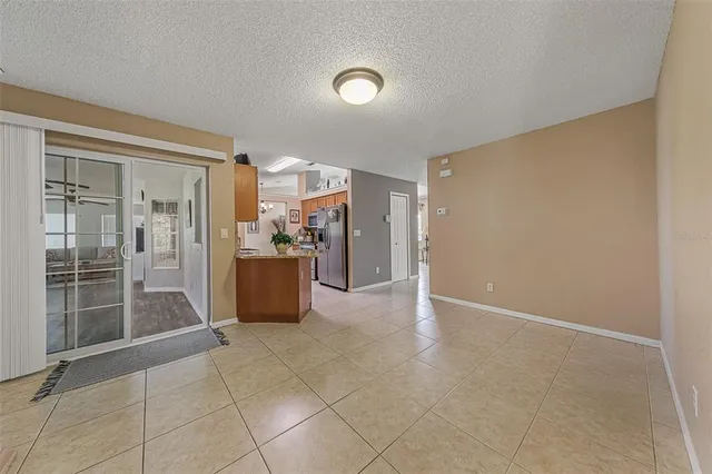 a view of an empty room with a kitchen