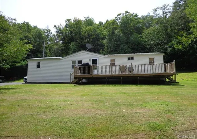 a view of a house with a backyard