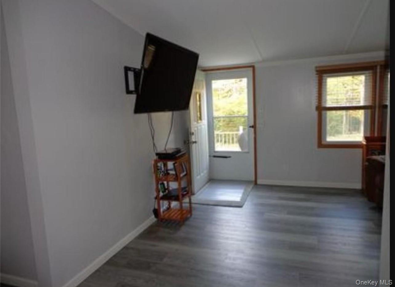 182-184 Mutton Hill Road Neversink, NY 12765 - Photo 12 of 34 an empty room with window and wooden floor