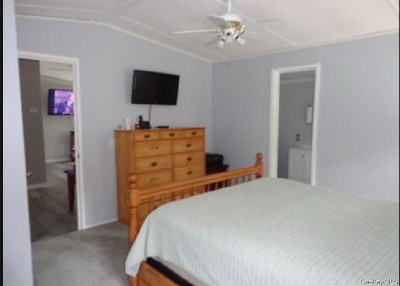 182-184 Mutton Hill Road Neversink, NY 12765 - Photo 15 of 34 a bedroom with a bed and a flat screen tv