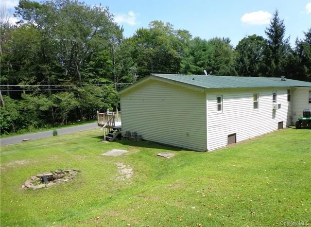 a view of a backyard with table and chairs and potted plants