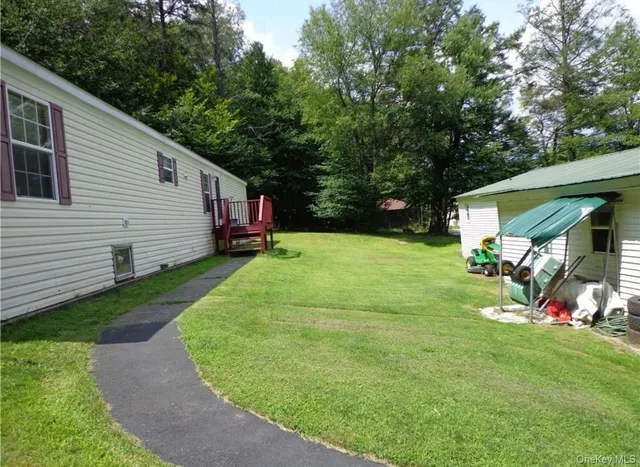 a view of a house with a yard porch and sitting area
