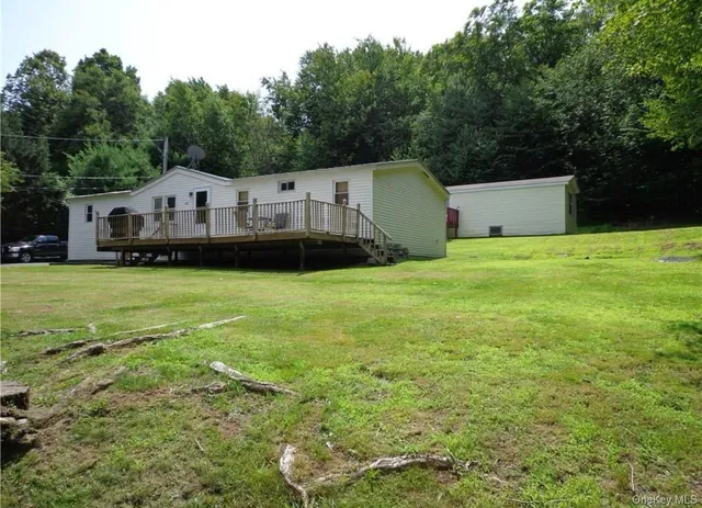 an aerial view of a house next to a big yard