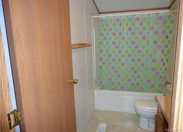 a bathroom with a shower curtain and sink
