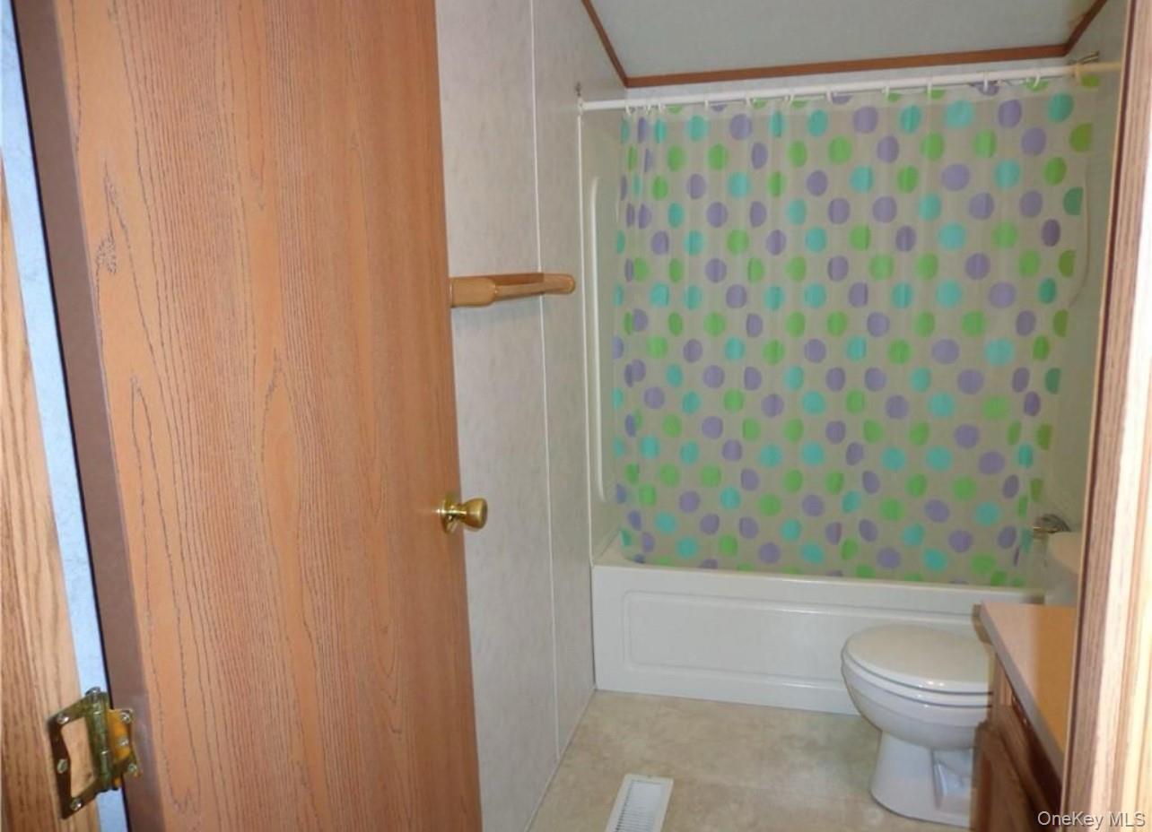 182-184 Mutton Hill Road Neversink, NY 12765 - Photo 23 of 34 a bathroom with a shower curtain and sink