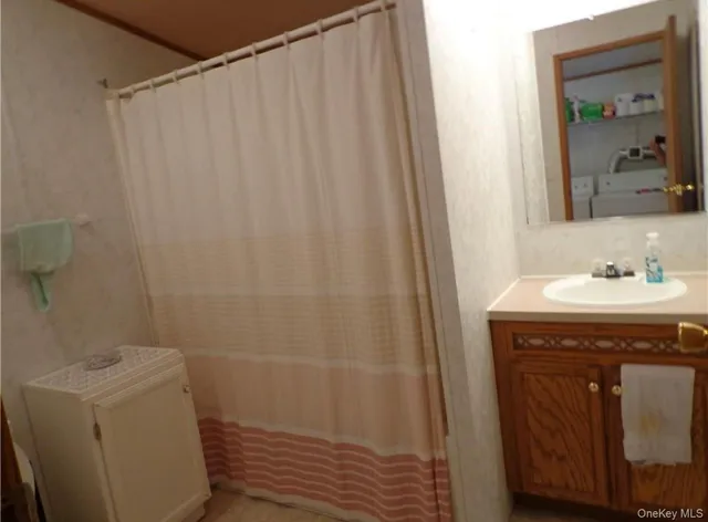 a bedroom with a bed and a mirror on dresser