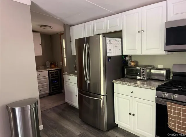 a kitchen with stainless steel appliances a refrigerator stove and microwave