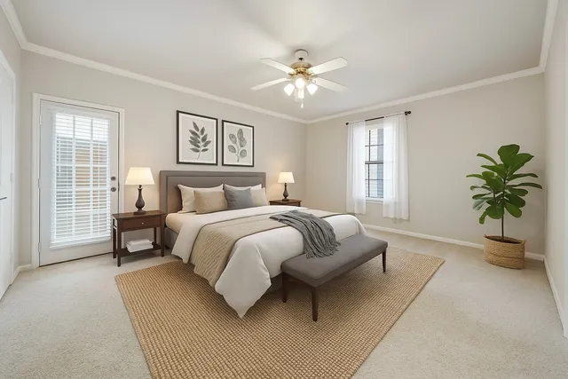 a bedroom with a large bed and a chandelier