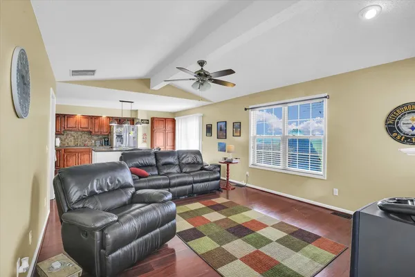 a living room with a fireplace and a flat screen tv