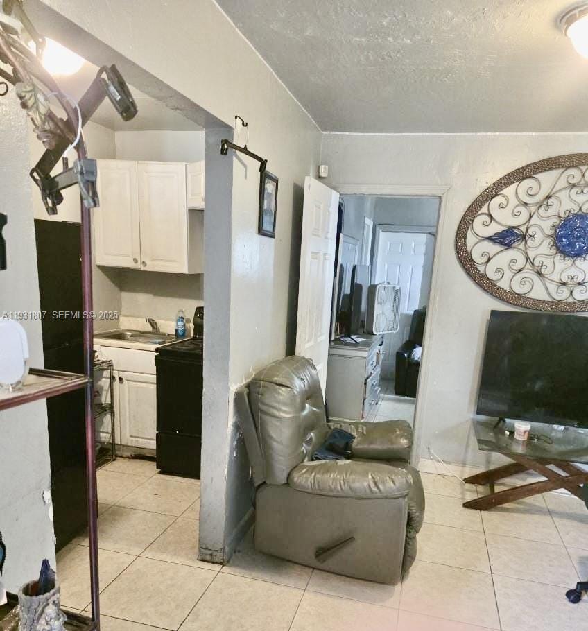 10280 Southwest 175th Street Miami, FL 33157 - Photo 2 of 10 a living room with furniture a flat screen tv and kitchen view