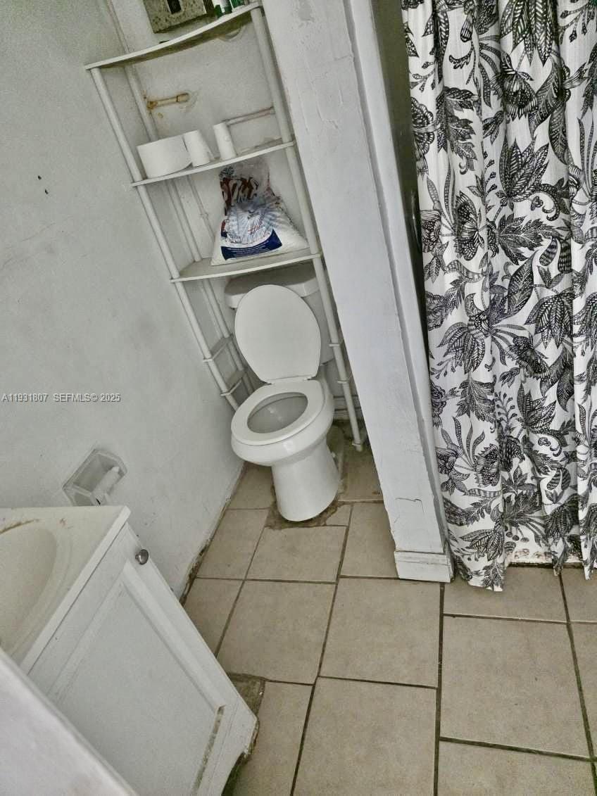 10280 Southwest 175th Street Miami, FL 33157 - Photo 3 of 10 a bathroom with a toilet and a sink
