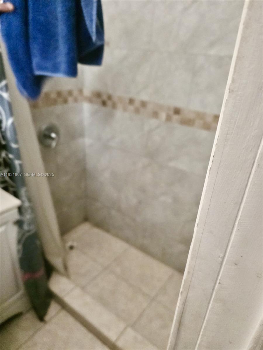 10280 Southwest 175th Street Miami, FL 33157 - Photo 4 of 10 a bathroom with a granite countertop shower and a toilet