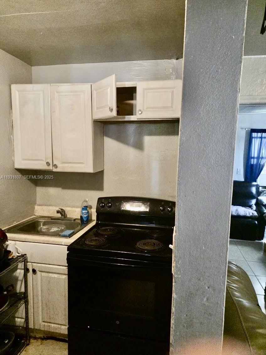 10280 Southwest 175th Street Miami, FL 33157 - Photo 6 of 10 a kitchen with a sink and a stove top oven