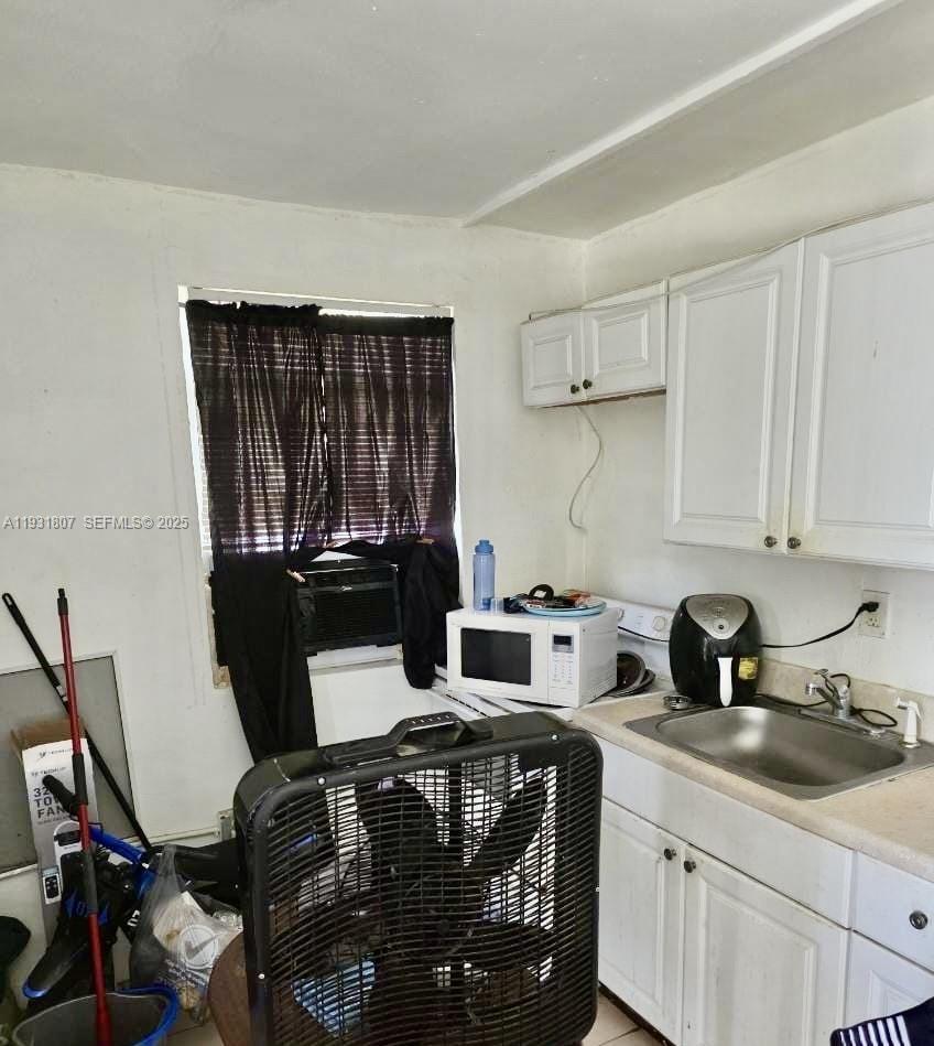 10280 Southwest 175th Street Miami, FL 33157 - Photo 7 of 10 a kitchen with a sink a stove and cabinets