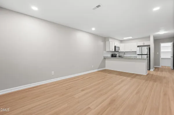 a view of a kitchen with a sink and a refrigerator