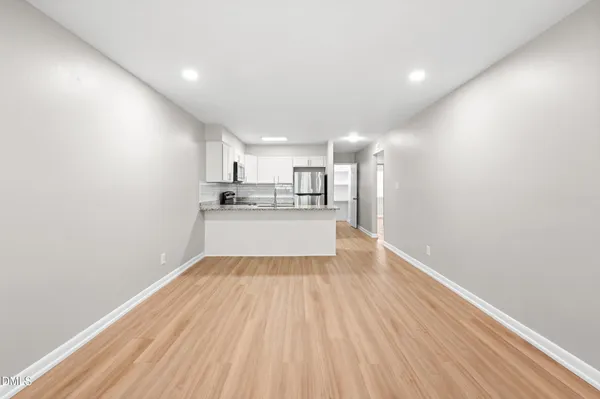 a view of a kitchen with wooden floor