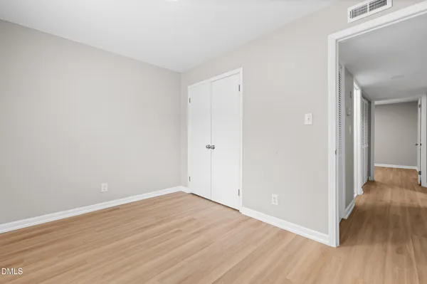 a view of a room with wooden floor
