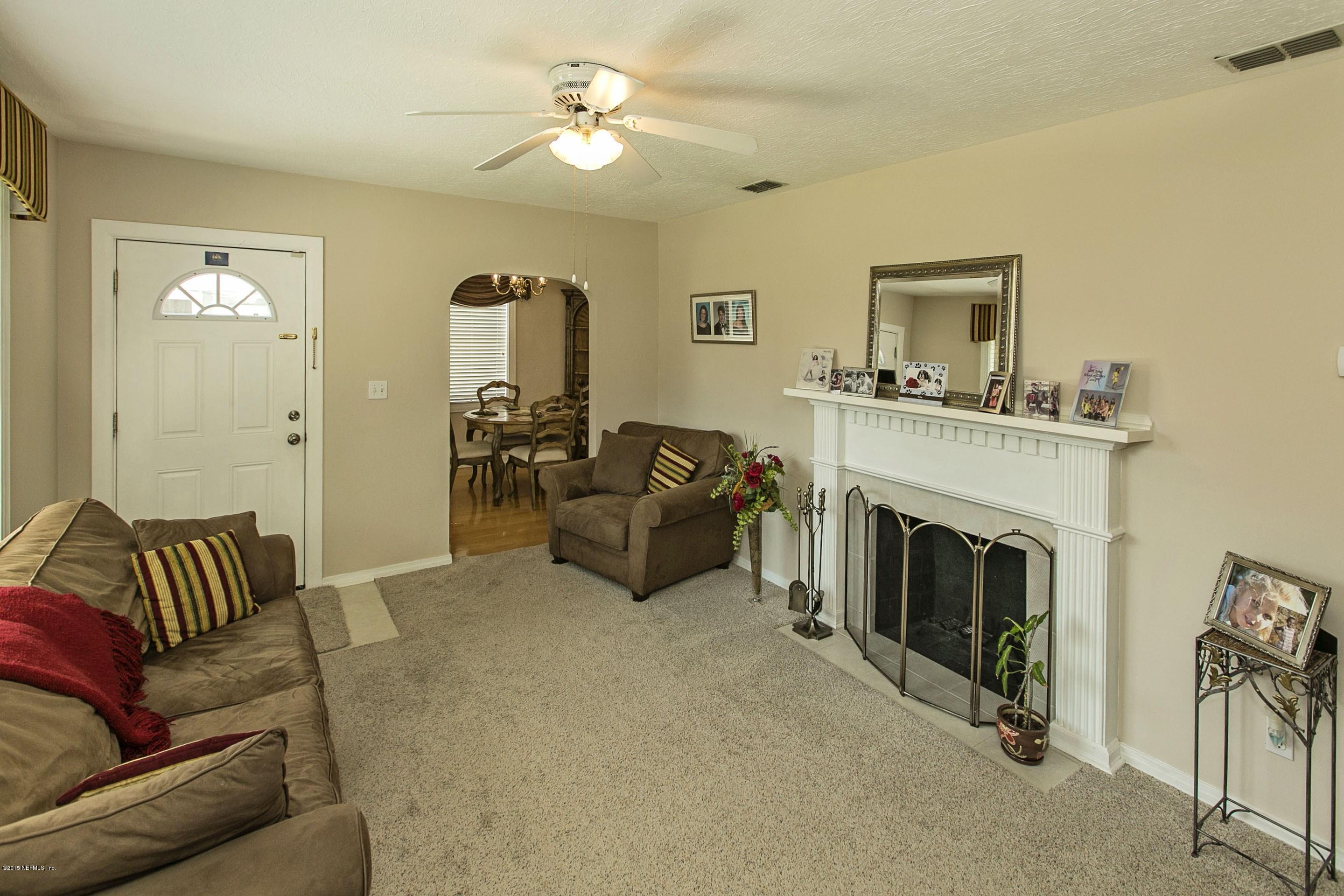 1712 Mayfair Road Jacksonville, FL 32207 - Photo 3 of 17 a living room with furniture and a fireplace
