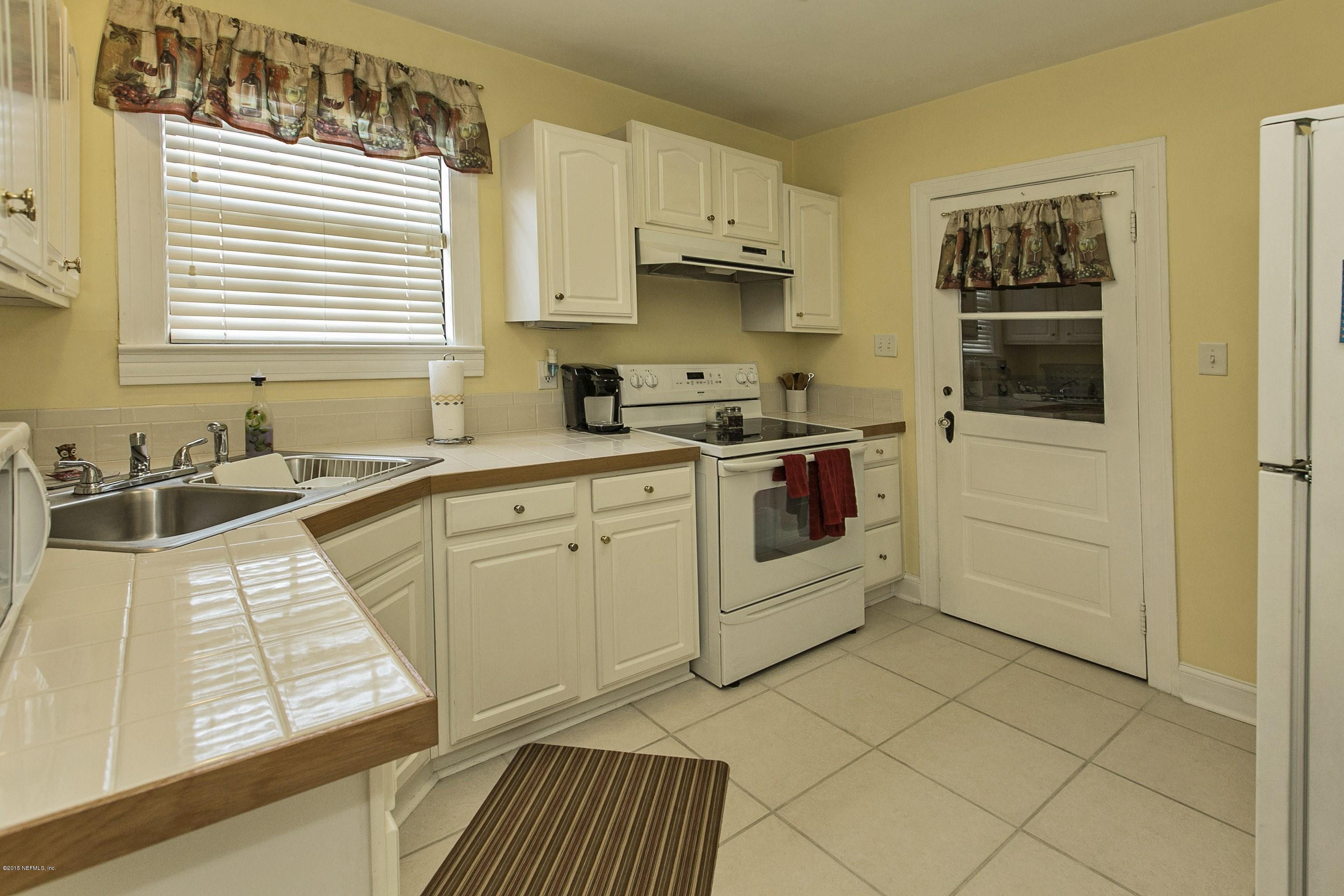 1712 Mayfair Road Jacksonville, FL 32207 - Photo 6 of 17 a kitchen with stainless steel appliances granite countertop a stove sink and cabinets
