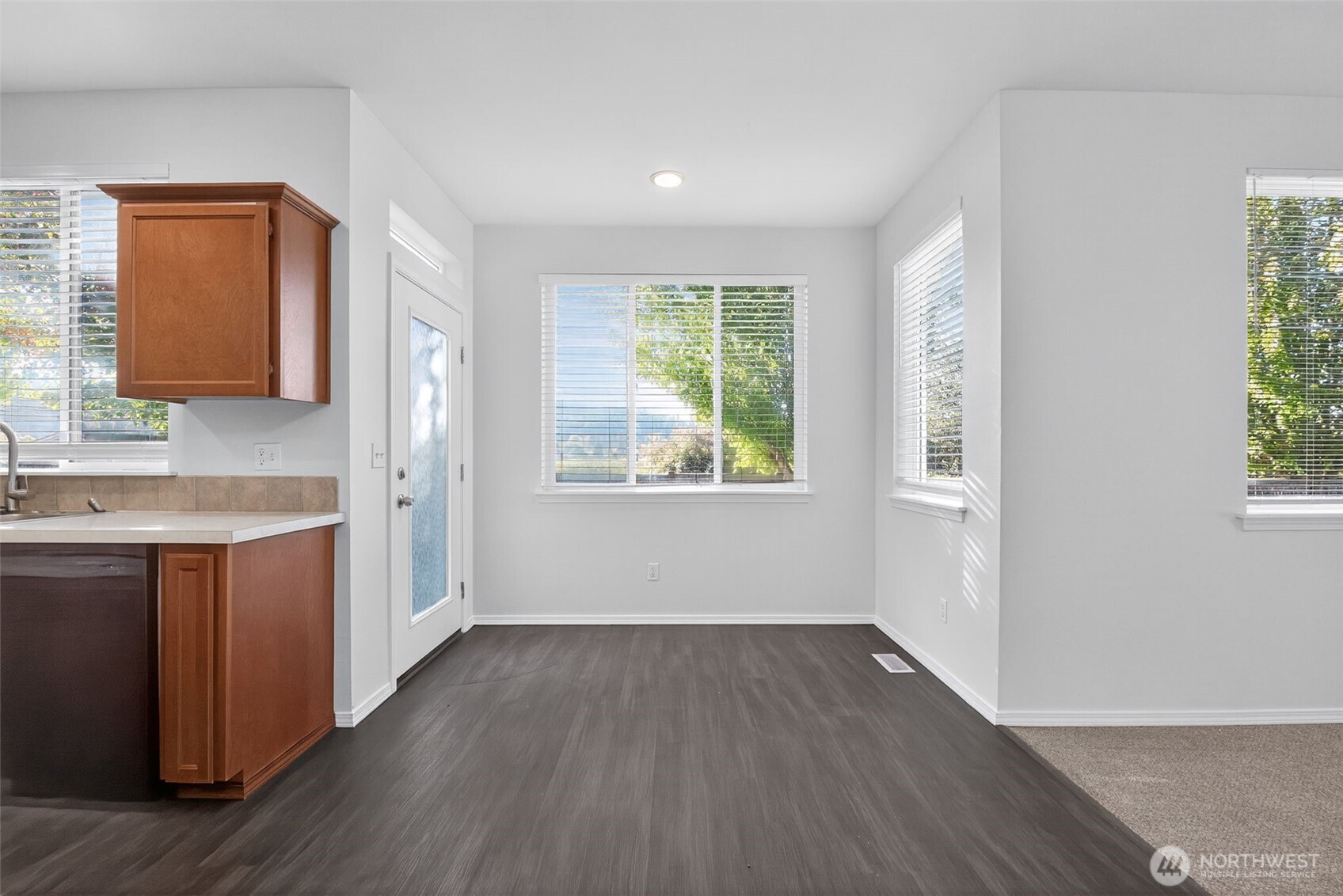 1005 Eagle Avenue Southwest Orting, WA 98360 - Photo 12 of 34 a view of kitchen with wooden floor and electronic appliances