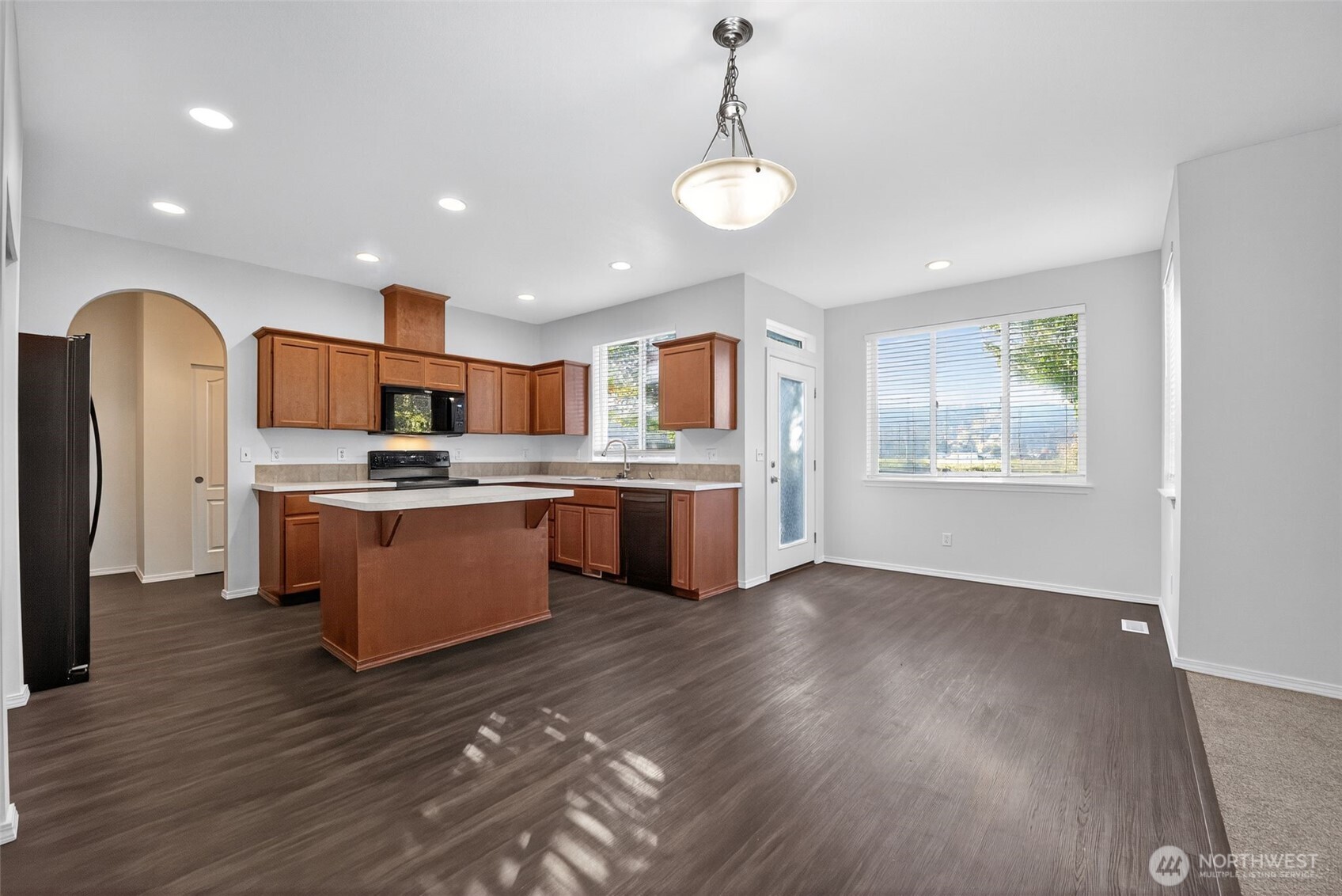 1005 Eagle Avenue Southwest Orting, WA 98360 - Photo 13 of 34 a kitchen with stainless steel appliances kitchen island granite countertop a stove and a refrigerator