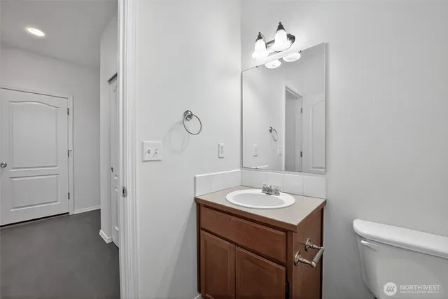 a bathroom with a sink vanity and a mirror