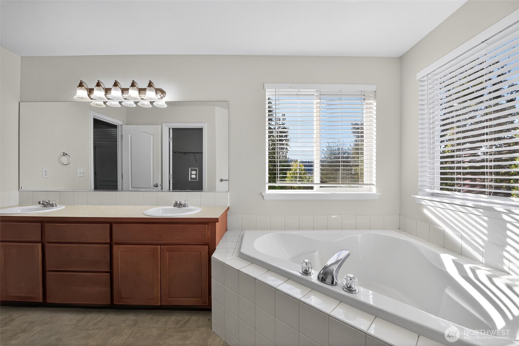 1005 Eagle Avenue Southwest Orting, WA 98360 - Photo 25 of 34 a bathroom with a tub sink and mirror