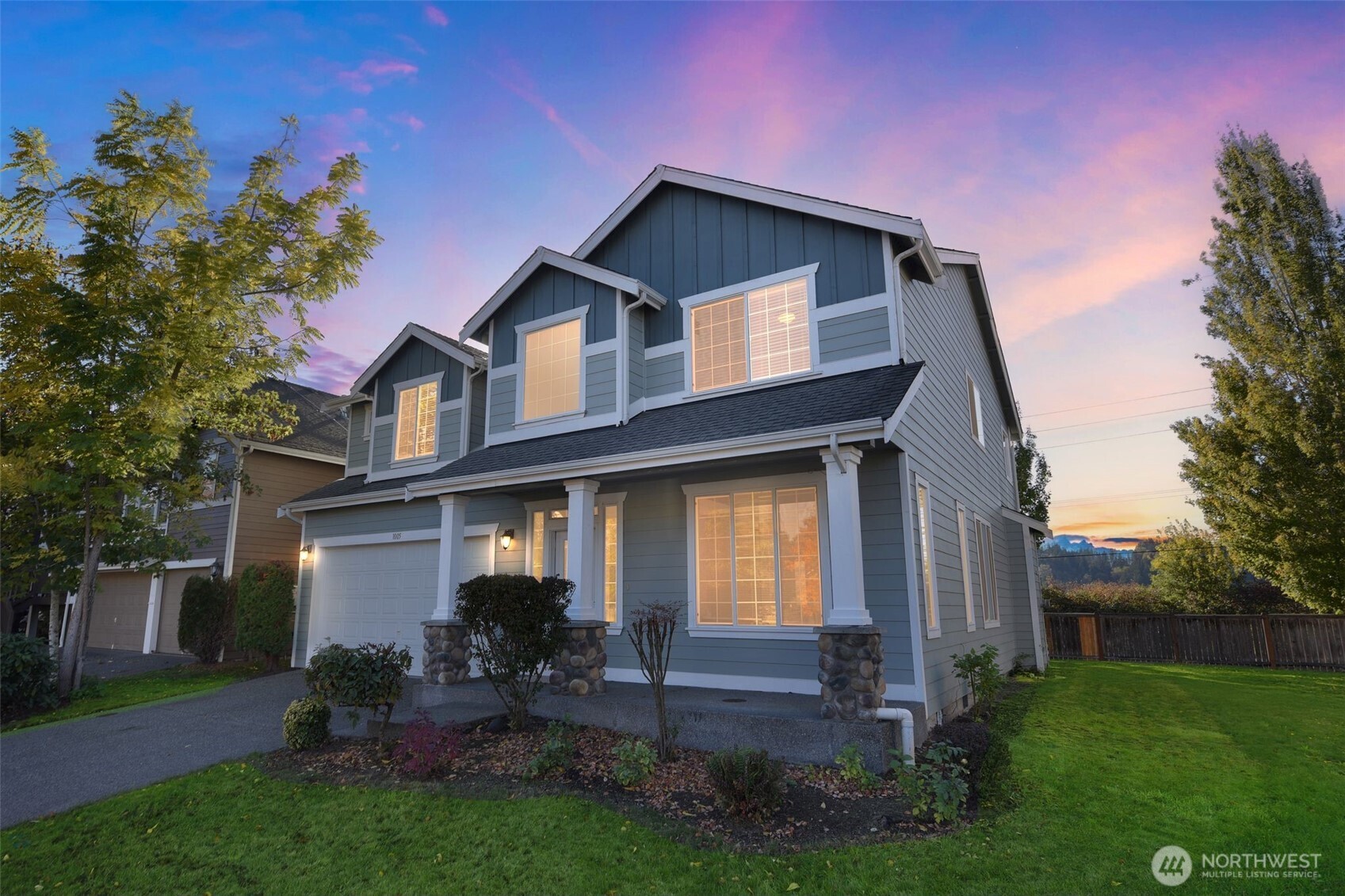 1005 Eagle Avenue Southwest Orting, WA 98360 - Photo 33 of 34 a front view of a house with a garden and plants