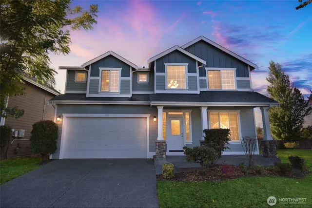 a front view of a house with a yard and garage