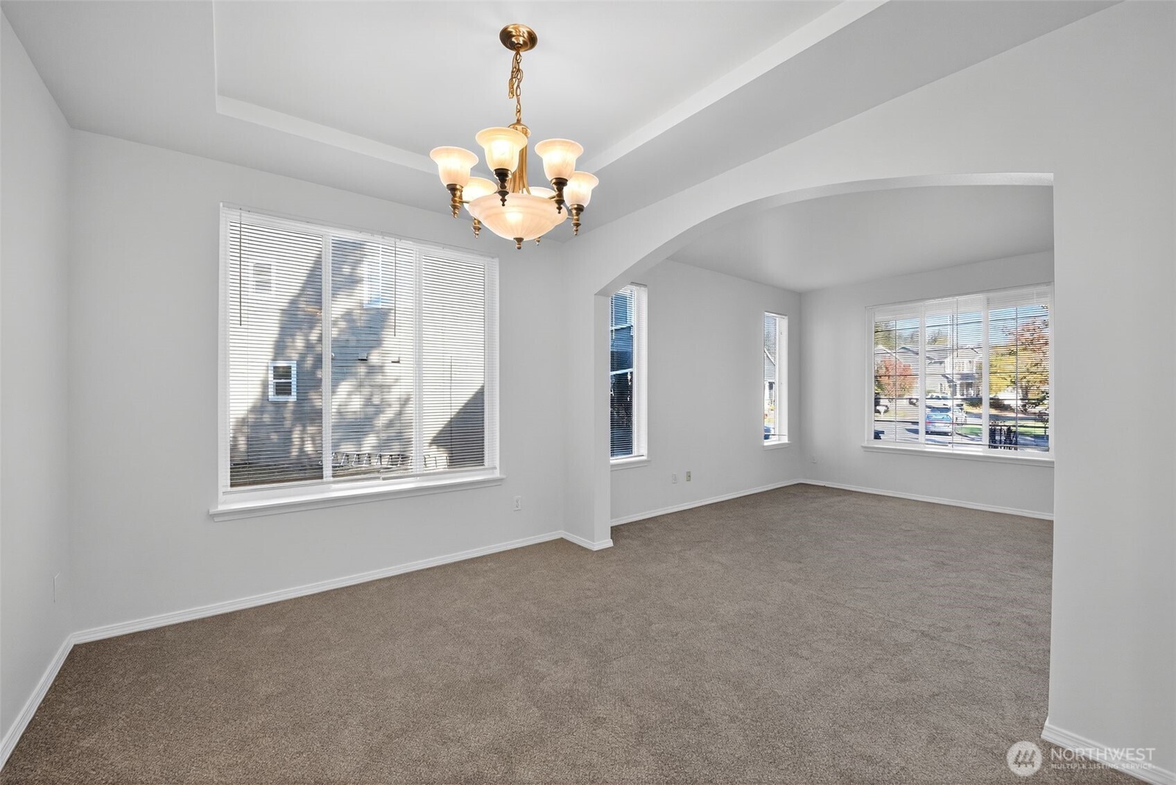 1005 Eagle Avenue Southwest Orting, WA 98360 - Photo 7 of 34 an empty room with windows and chandelier