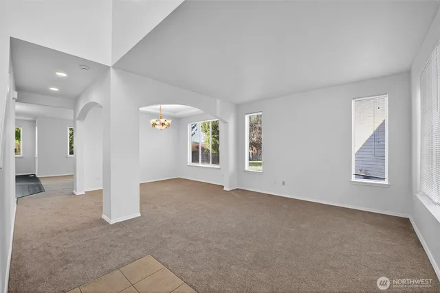 an empty room with windows and entrance