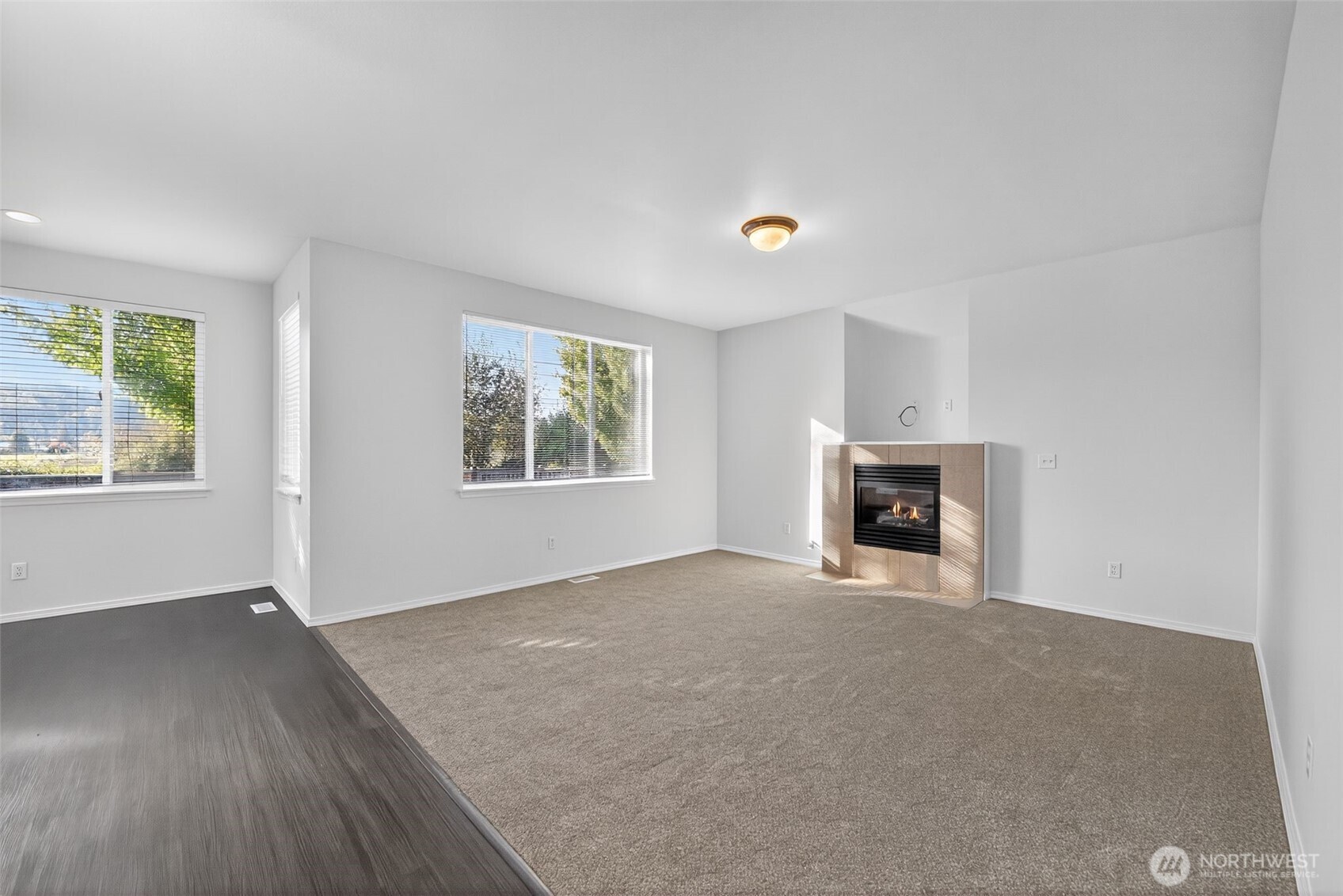 1005 Eagle Avenue Southwest Orting, WA 98360 - Photo 10 of 34 an empty room with windows and fireplace