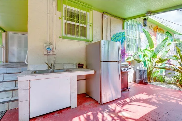 a backyard of a house with yard and outdoor seating