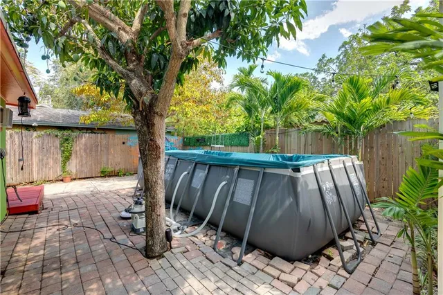 a view of a backyard with plants and a bench