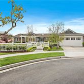 a view of house with a yard and potted plants